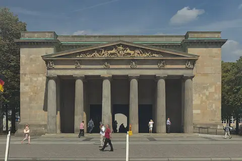 Front of a square stone guardhouse with a Doric portico and a sculpted pediment, with passers-by walking in front.