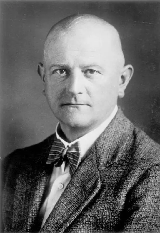 Head-and-shoulders portrait of a man in a dark suit and tie
