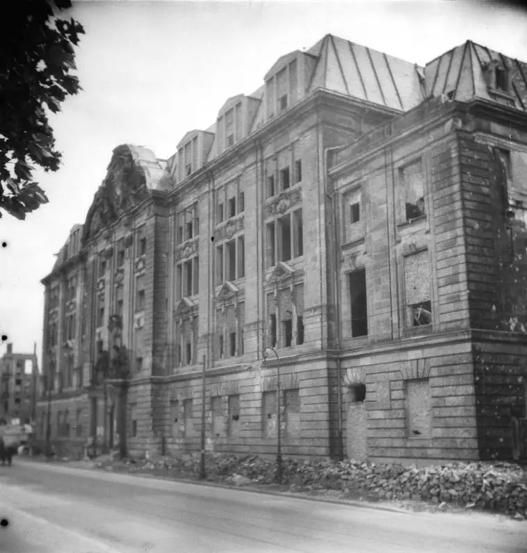 The bombed-out shell of a large stone building with empty window openings