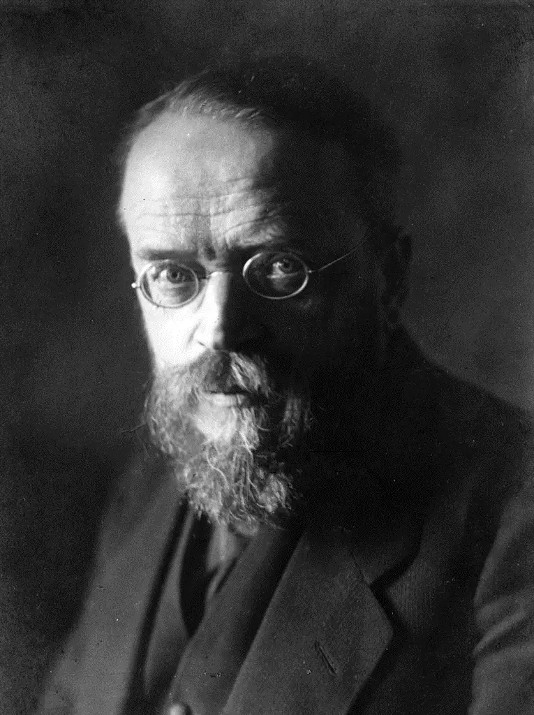 Portrait of a bearded man with round wire-rimmed spectacles