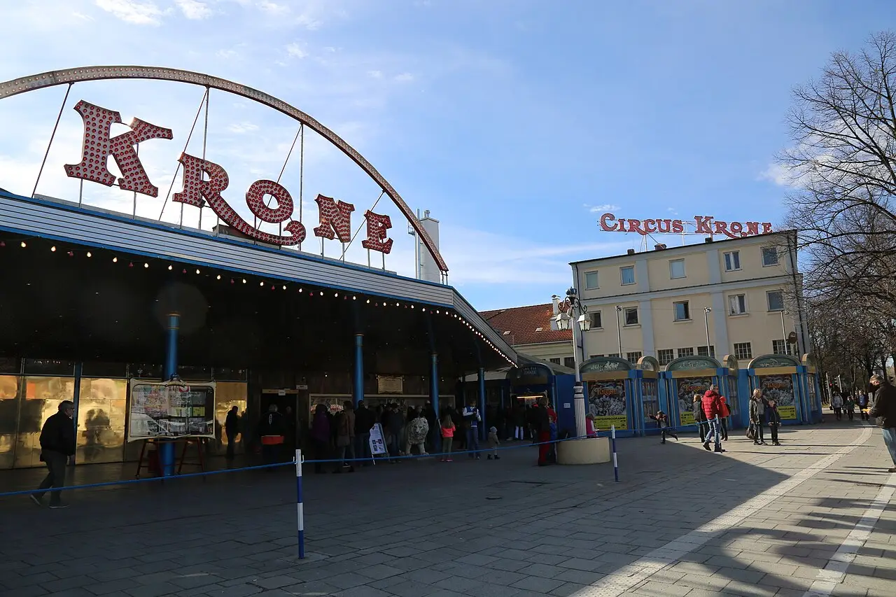 The modern entrance of a large circus building with a sign reading 'Circus Krone'.