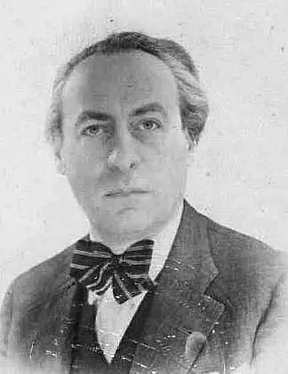 Head-and-shoulders portrait of a man with swept-back hair, wearing a dark jacket and a large polka-dot bow tie.
