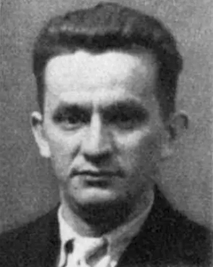 Head-and-shoulders portrait of a man with short hair in a jacket and collar