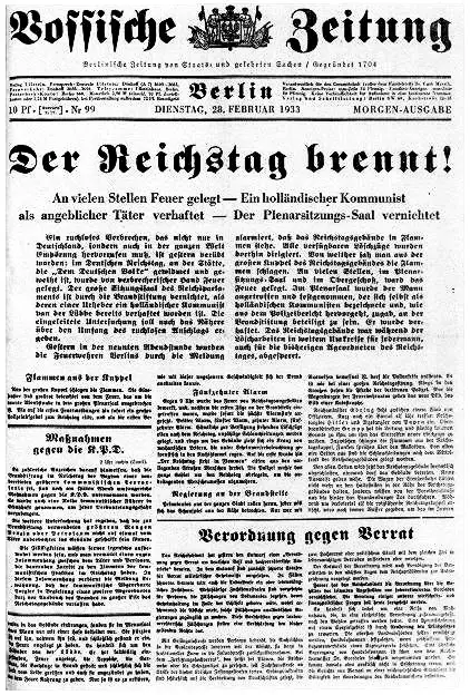 A newspaper front page in black-letter type under the masthead Vossische Zeitung, with the large headline 'Der Reichstag brennt!' over dense columns of text.
